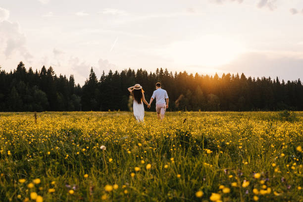 istock Running loving couple in the field. Sunset. 1211720496