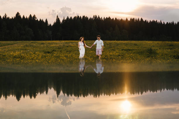 istock Running loving couple in the field. Sunset. 1211720501