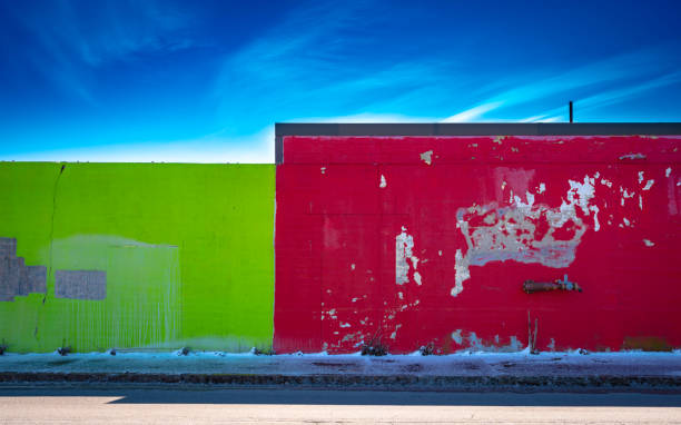 istock Two abandoned city buildings with paint peeling from walls 1211720620