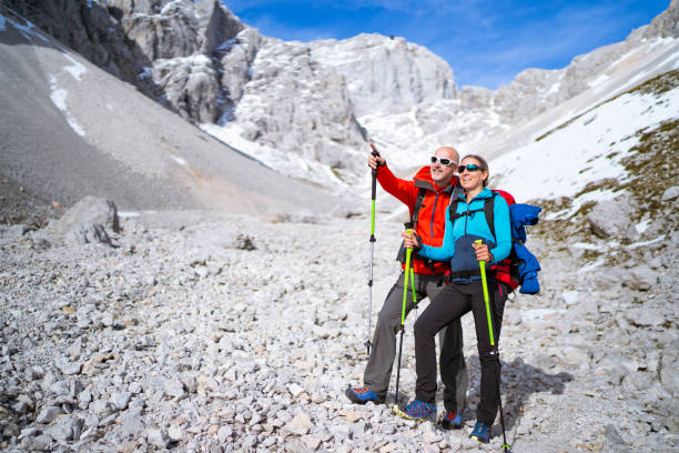 istock smiling hiking couple on scree in mountains 1211721685
