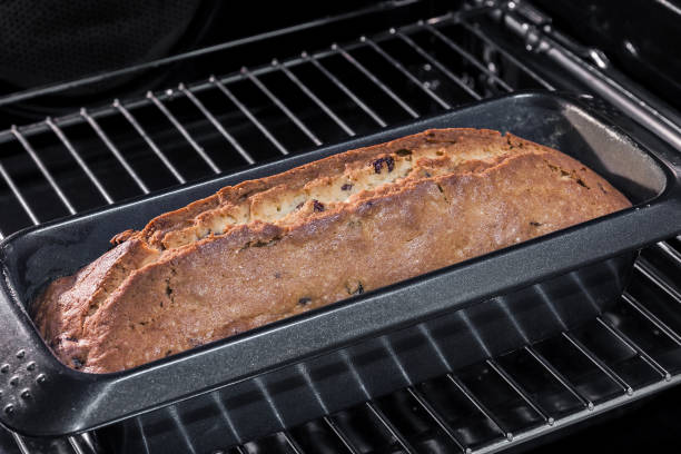 istock Homemade rectangular traditional cupcake with raisins in baking dish in an open oven. Closeup, selective focus 1211723242