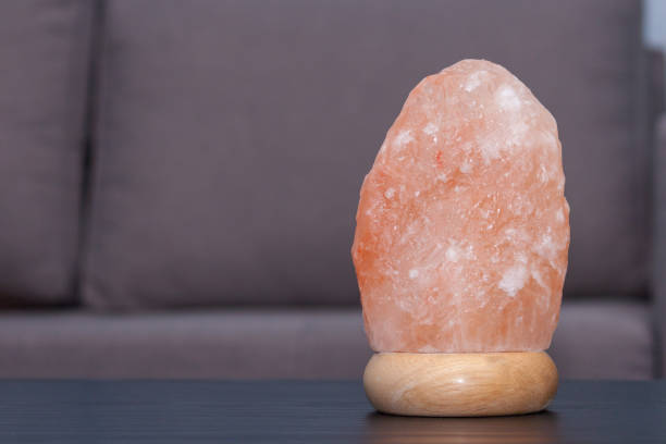 istock Himalayan pink salt lamp on table indoors 1211723635