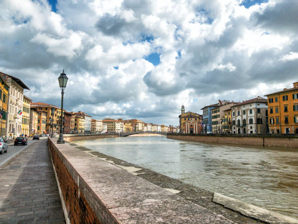Pisa, Italy. Lungarni with buildings and traffic.