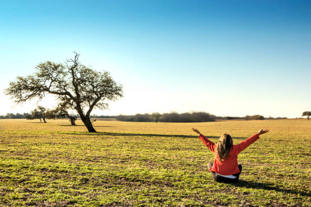 istock Woman practicing spiritual exercises in the field. 1211727807