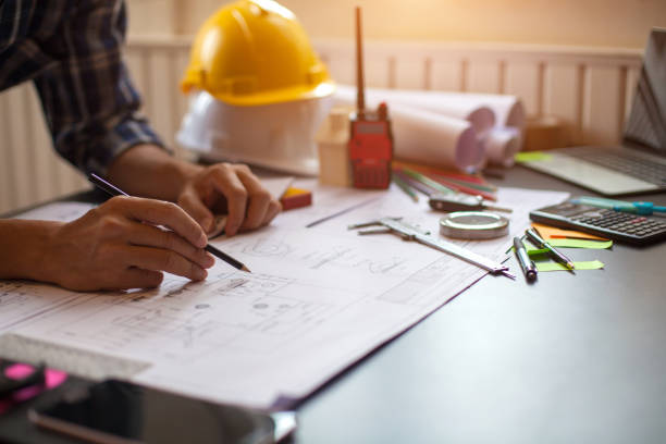 istock Concept Architect and desk of Architectural project in construction site or office building with mining light 1211727829
