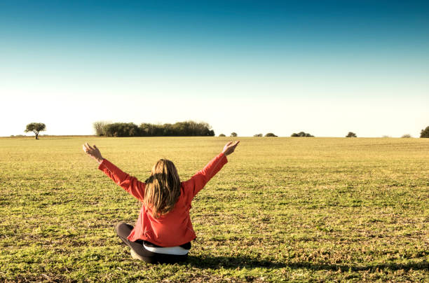 istock Woman practicing spiritual exercises in the field. 1211727963