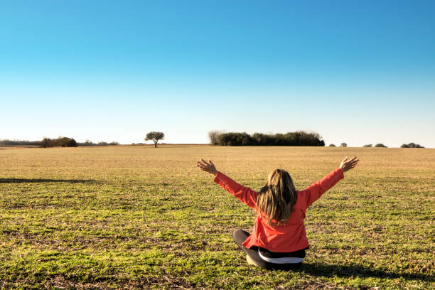 istock Woman practicing spiritual exercises in the field. 1211728134