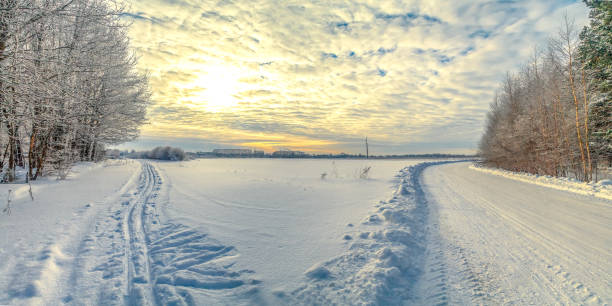 istock The sun shines through the clouds on a deserted snowy landscape 1211728200
