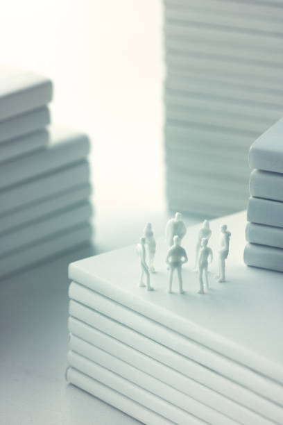 istock Stacked white books and human 1211729031
