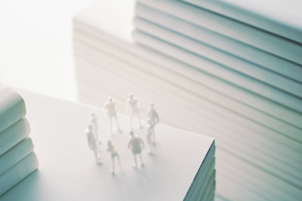 istock Stacked white books and human 1211729046