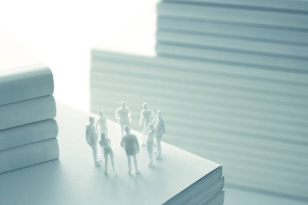 istock Stacked white books and human 1211729069