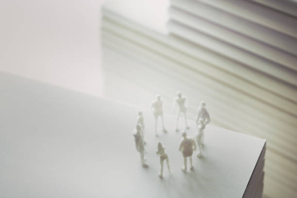 istock Stacked white books and human 1211729088