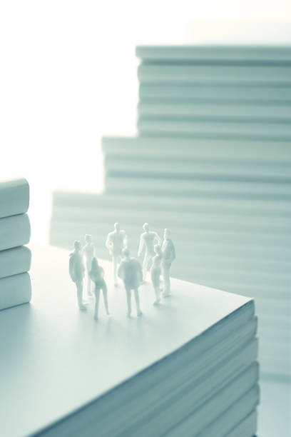 istock Stacked white books and human 1211729126
