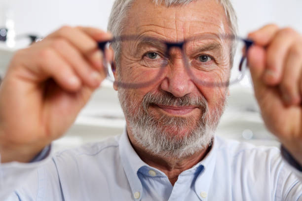 istock Senior trying new eyeglasses 1211732569