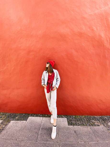 istock Woman on the red wall background 1211733683
