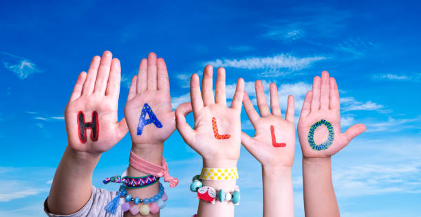 istock Children Hands Building Word Hallo Means Hello, Blue Sky 1211735375