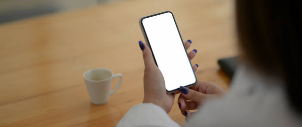 istock Close up view of female university student using mock-up smartphone 1211736924