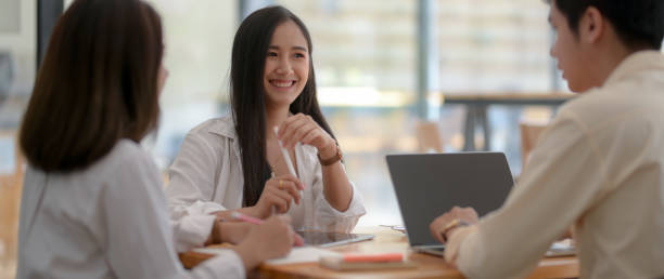 istock Cropped shot of university students group working on their assignment together 1211737536