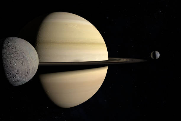istock Enceladus orbiting around the Saturn planet together to Mimas. 3d render 1211739627