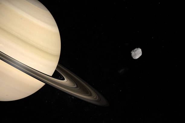 istock Janus moon orbiting around Saturn planet in the outer space. 3d render 1211739704