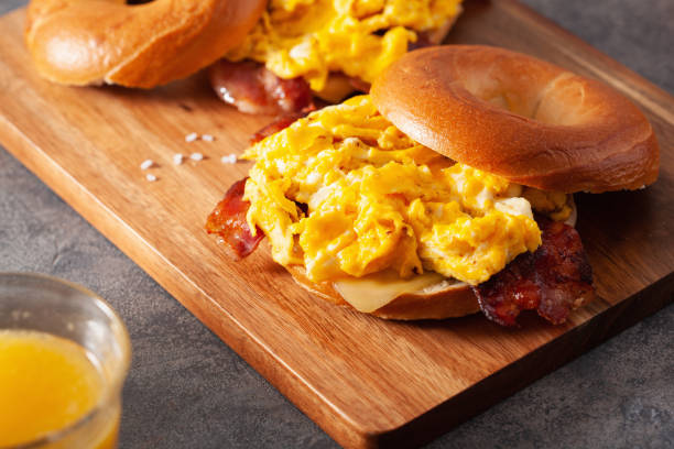 istock breakfast egg and bacon sandwich on bagel with cheese 1211740569