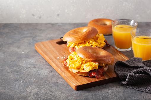 breakfast egg and bacon sandwich on bagel with cheese