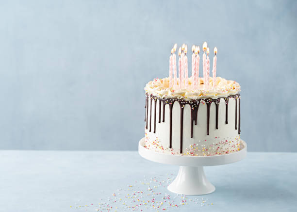 birthday drip cake lots of pink candles with chocolate ganache and sprinkles on a light background, banner. copy space. celebration concept. trendy drip cake. - copy space single object confetti nobody imagens e fotografias de stock