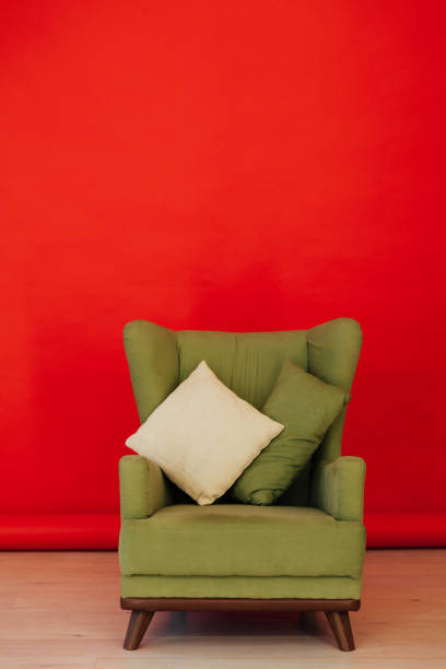 istock red black background green chair with pillows for rest 1211743093