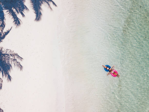istock Women in a bikini enjoys the tropical sun 1211744680