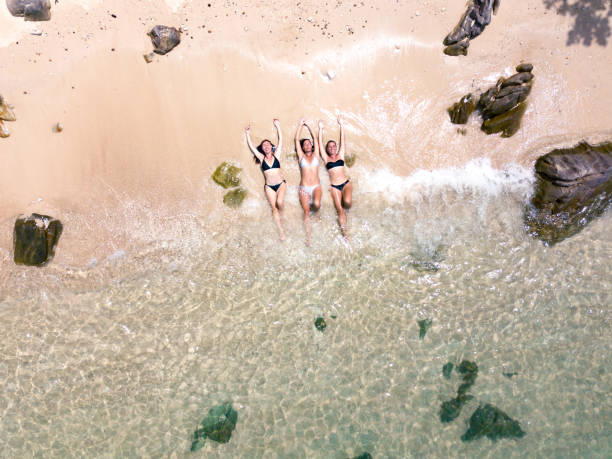 istock Women in a bikini enjoys the tropical sun 1211744764