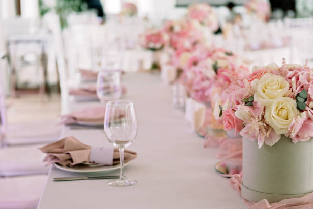 istock Table setting with flowers and candles at a luxurious wedding reception. 1211746308