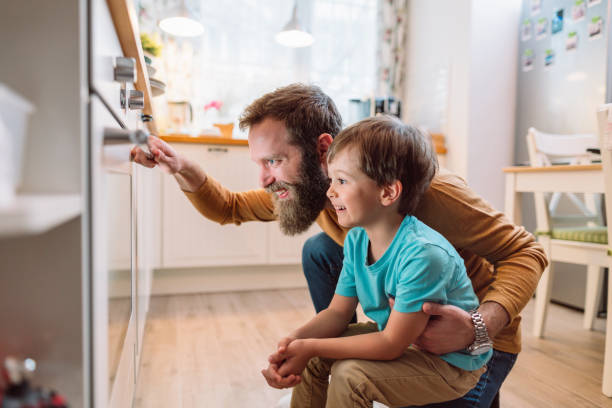 istock Little boy cooking together with dad 1211746368