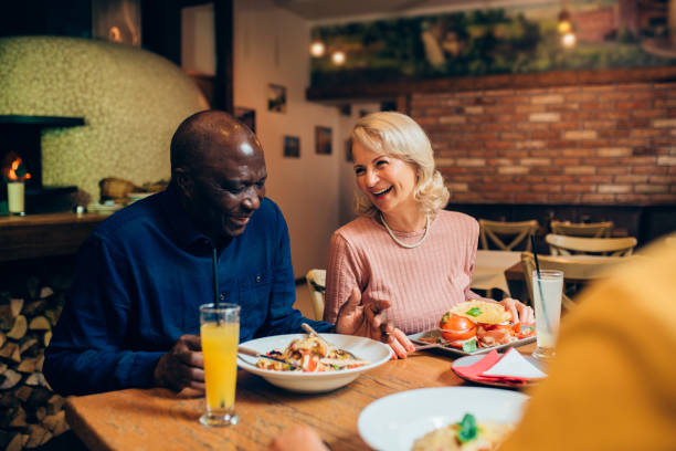 istock Seniors enjoying dinner together 1211747263