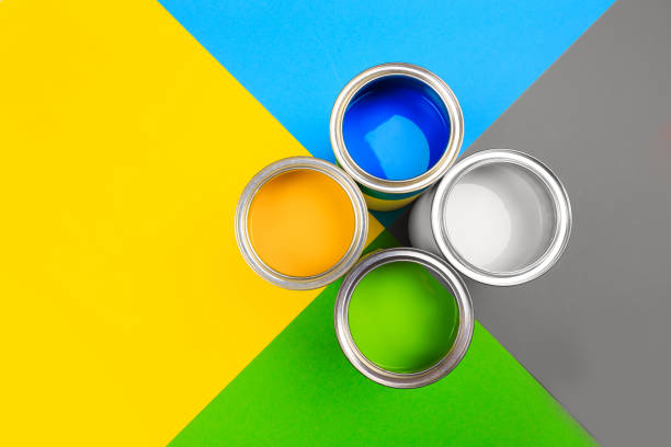 istock Metal paint cans and paint brushes on multicolor background. Top view. Copy space. 1211748807