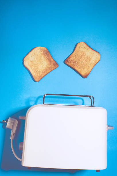 Toaster with slices of bread on a blue background, space for text. top view vertical photo. Flat lay