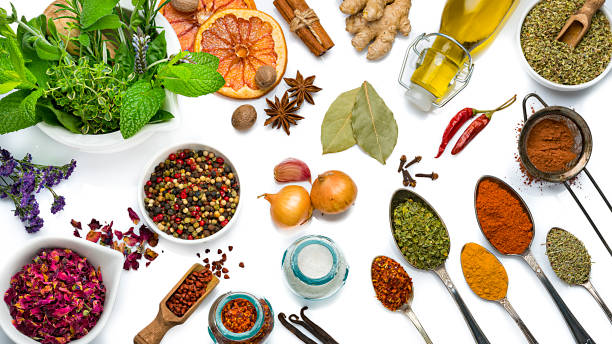 cooking and seasoning ingredients: vegetables, herbs and spices on white background - mortar and pestle condiment isolated food imagens e fotografias de stock