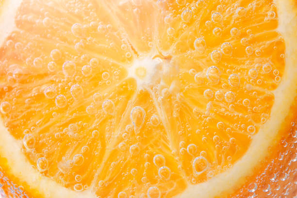 istock orange fruit, citrus vitamins . Orange slice and the external part close up. macro under water in water, fresh fruit for juice. bright juicy fruit, selective focus 1211752016