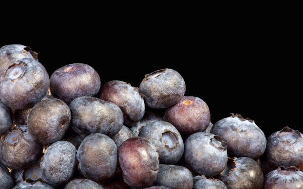 istock blueberry heap isolated on black background 1211755714