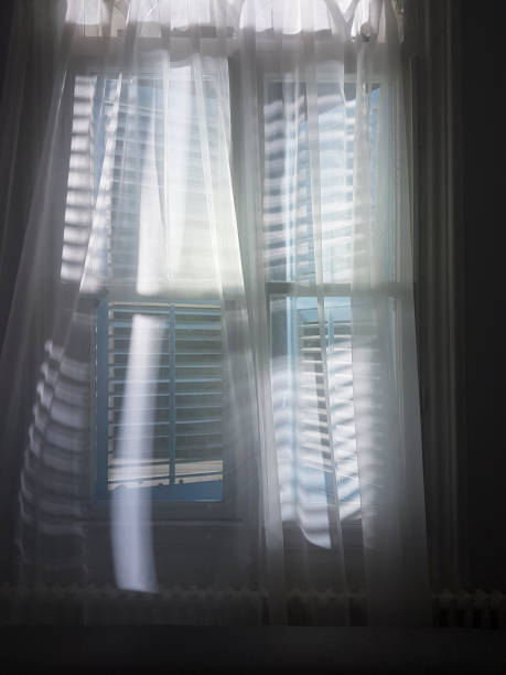 istock White curtain hanging in the window 1211755778