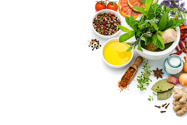 cooking and seasoning ingredients: vegetables, herbs and spices on white background - mortar and pestle condiment isolated food imagens e fotografias de stock