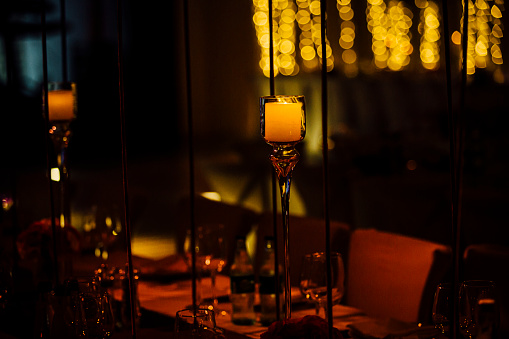 Romantic candle in beautiful dark evening light for events. Luxury events or weddings. Design element. \