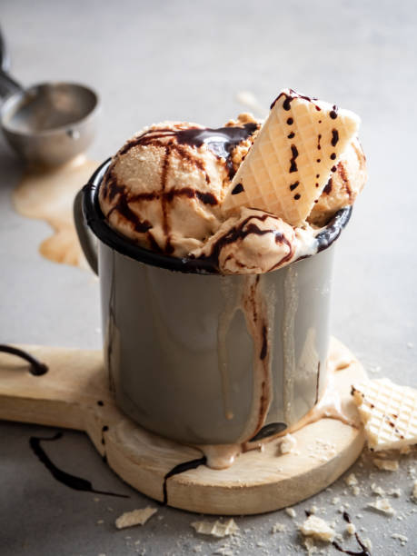 istock Vanilla ice cream ball melted with chocolate sauce in a rustic mug 1211757767