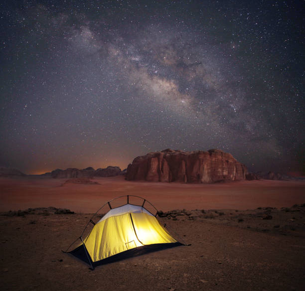 istock Camping in Wadi Rum desert under starry sky with Milky Way 1211757908