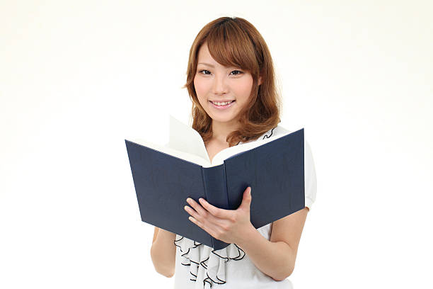 istock Young asian business woman holding a book 121176232