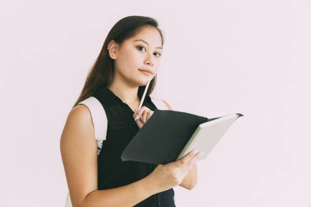 istock Serious pensive student girl reading her notes 1211762641