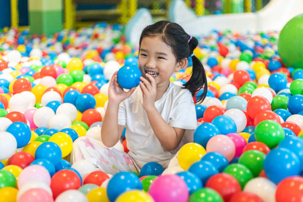 istock Cute girl at the Ball Pool 1211764612