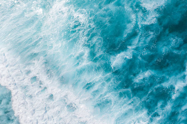 istock Big ocean waves hitting a coral rif. View from above. 1211764810