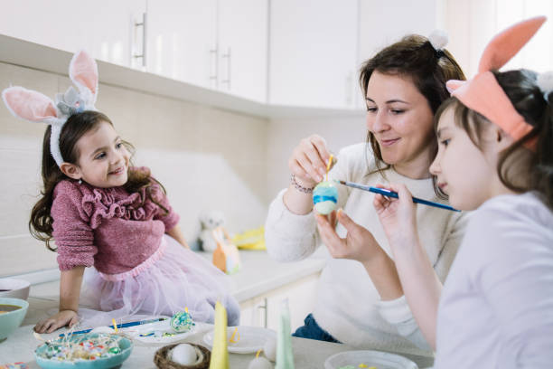 istock Young mother and daughters celebrating Easter holiday 1211764837