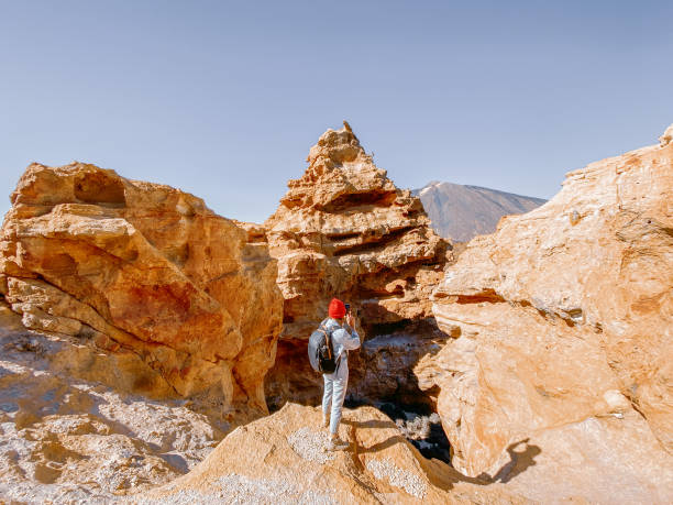 istock Traveler enjoying beautiful landscapes standing between huge rocks 1211765404