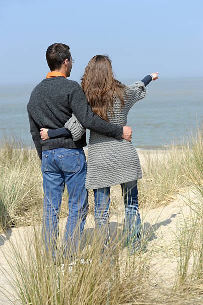 istock young couple looking at the ocean 121176570